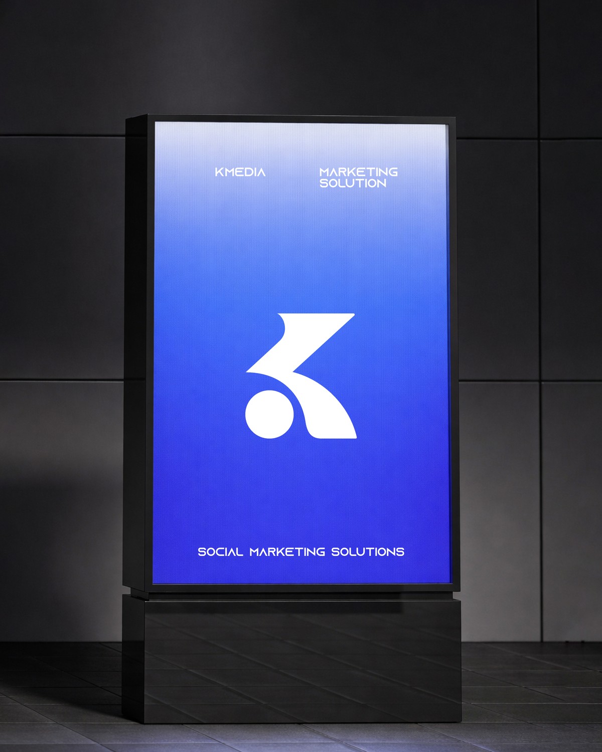 KMEDIA outdoor light-box signage at night