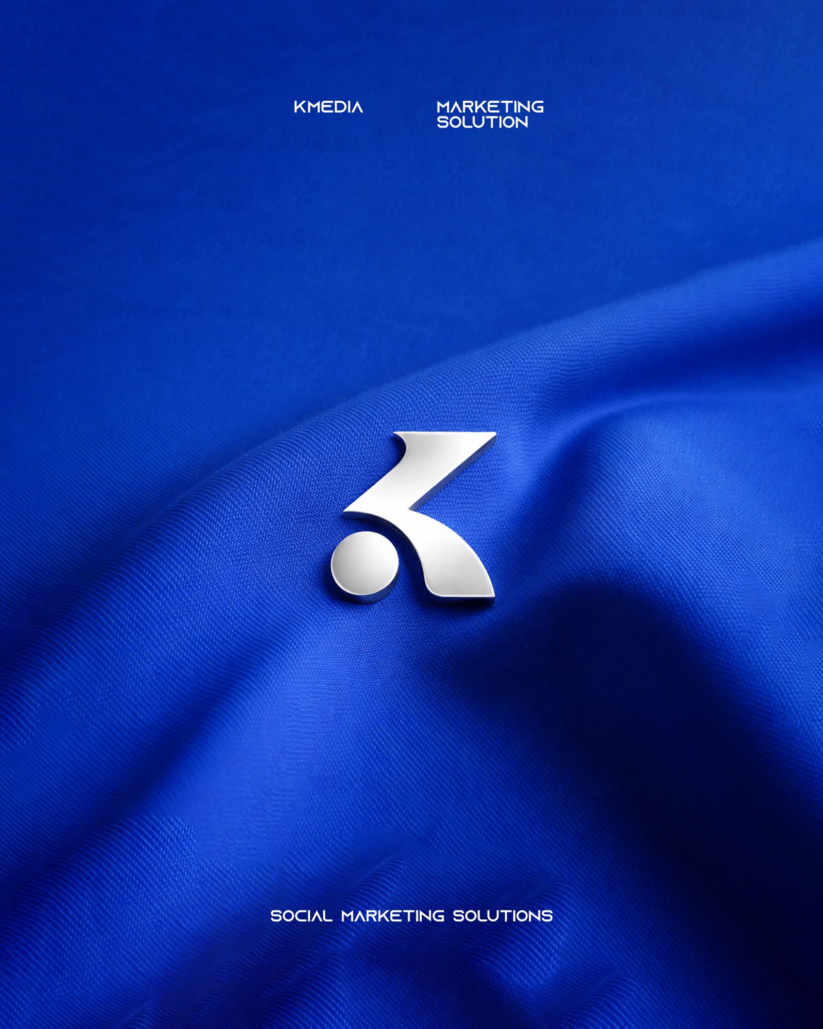 KMEDIA brand pin on blue silk